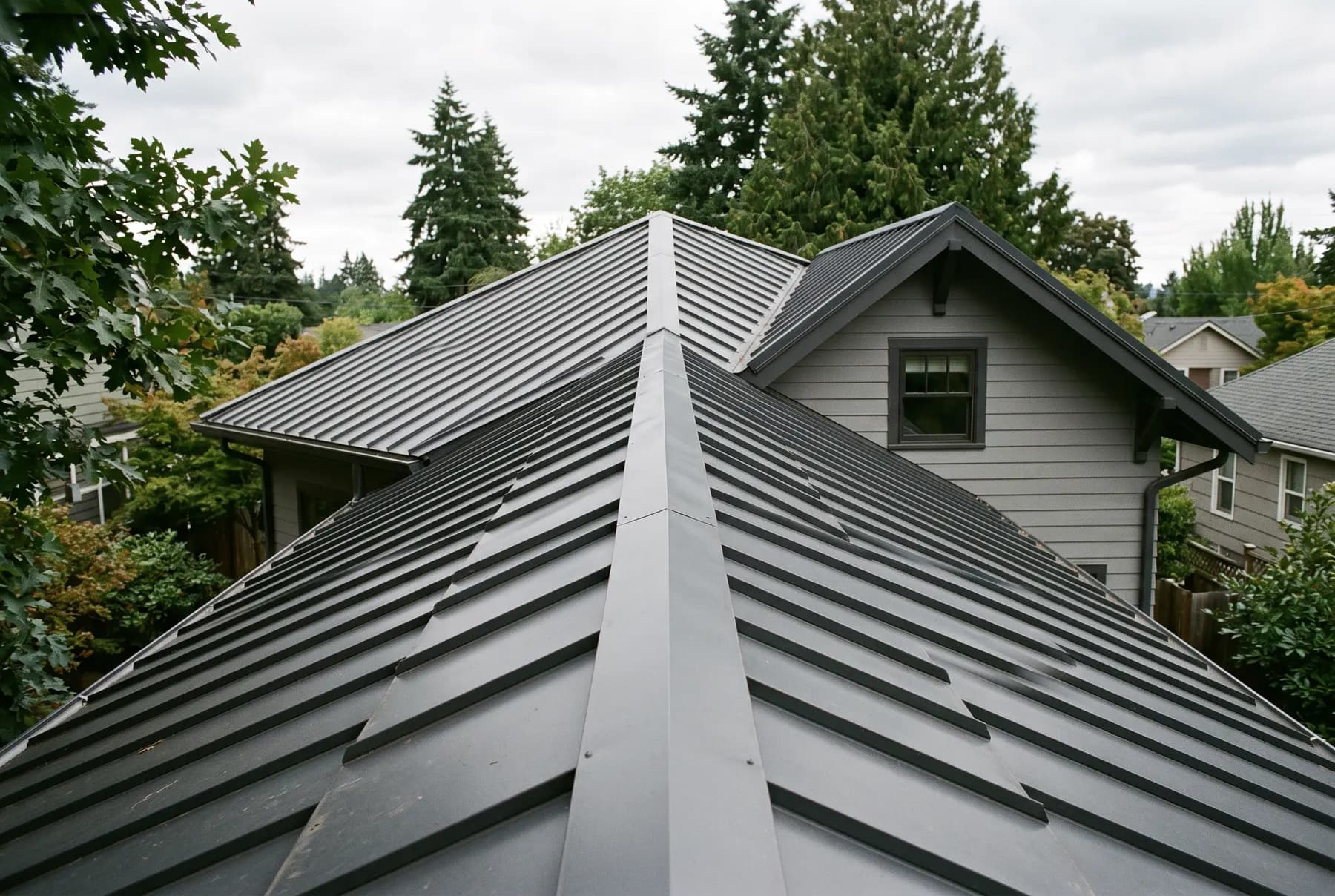A standing seam metal roof seen along the panels running to the ridge.